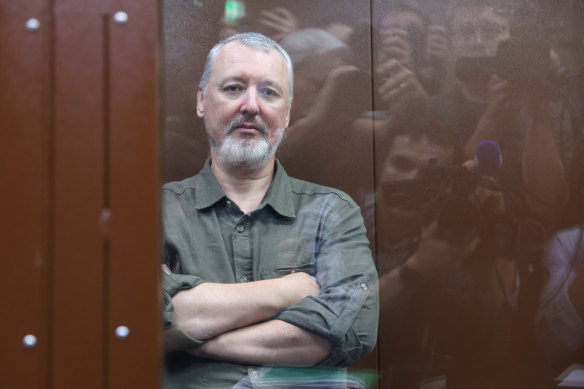 Russian nationalist Igor Girkin sits behind a glass wall of an enclosure for defendants before a court hearing in Moscow.