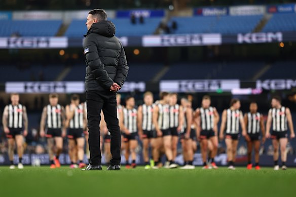 Craig McRae watches the Magpies leave the field.