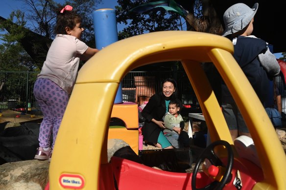 Emily Boon and her two-year-old son Kobe, centre, at SOCCS in Homebush West.