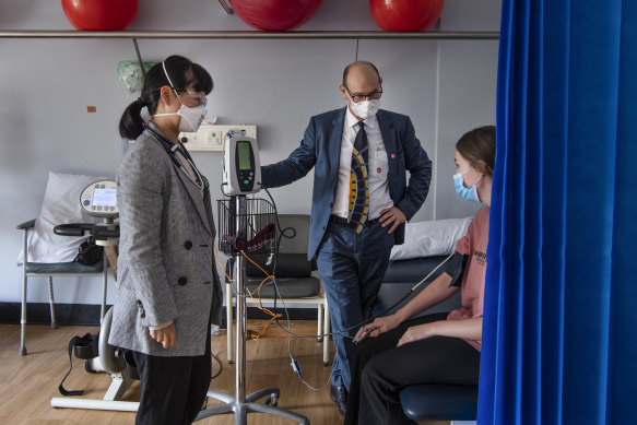 Professor Steven Faux and Dr Morgan Hee (left) meet with long COVID patient Payton Jacobs in March.