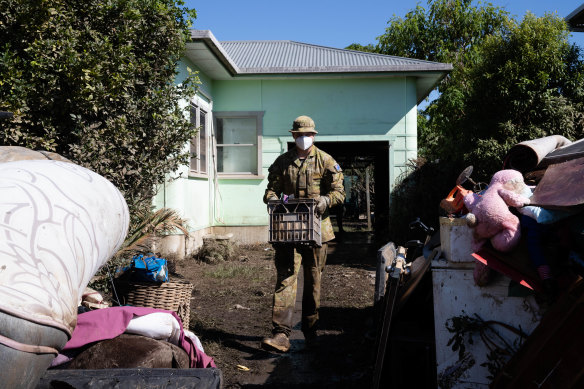 Members of the ADF help locals to clear their flood damaged homes in Broadwater.