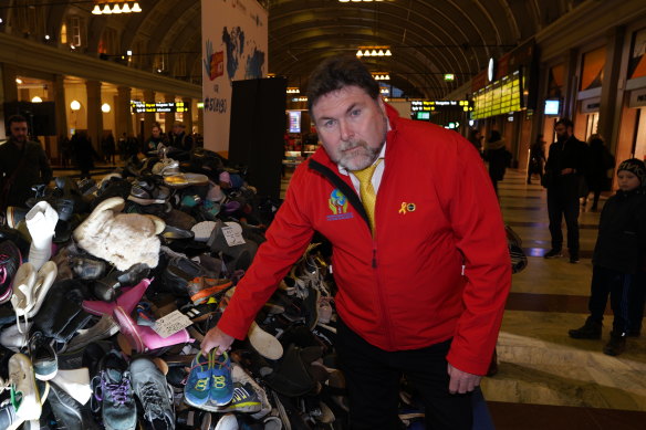 Peter Frazer adds a pair of shoes to a pile representing the 3700 people who die on the streets every day. Peter’s daughter Sarah died eight years ago in a road crash. He lobbied for more than seven years for the introduction of Sarah’s law. 