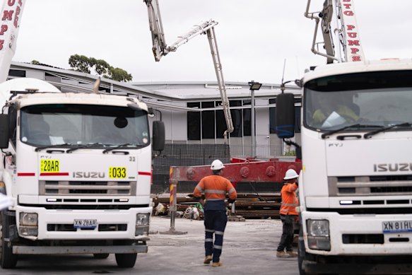Workers fill in a large sinkhole with cement in March 2024 to stabilise a two-storey building that had teetered on the edge.
