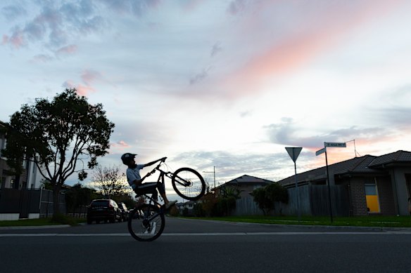 A boy rides his bike.