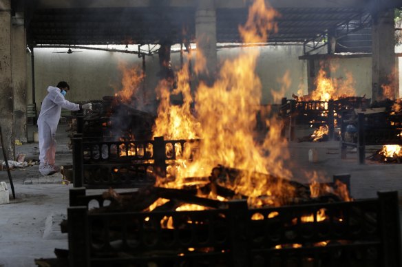 Flames rise from cremation pyres of 13 COVID-19 patients who died in a blaze that broke out in the Vijay Vallabh COVID-19 hospital, at Virar, near Mumbai, on Friday,
