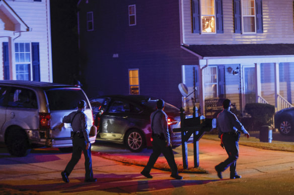 Raleigh police officers walk door-to-door checking on residents following the shooting.