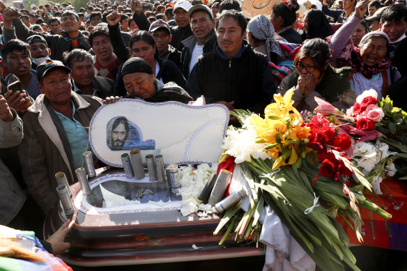 People stand next to the coffin of a supporter of former president Evo Morales killed during clashes with security forces, in Sacaba, Bolivia, on Saturday.