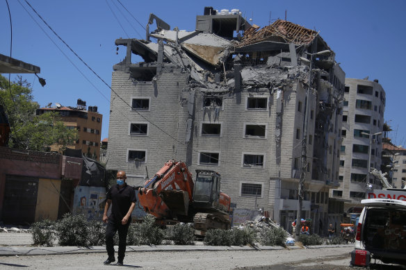 A Palestinian walks past a building hit by an Israeli air strike in Gaza.