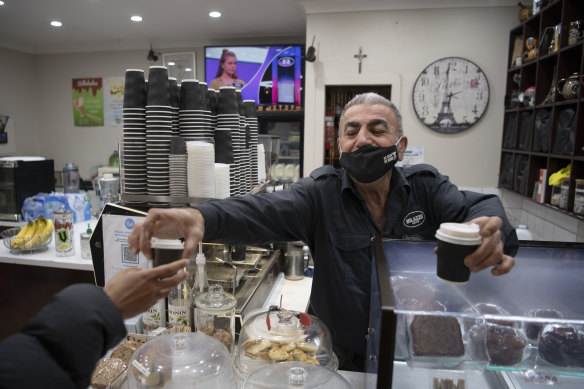 Salah Marbin hands out coffee in Fairfield on the state’s first day of reopening.