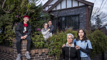 Auron Yi, Petra Yi, Peter Yi, Thi Xuan Dao Nguyen, Aliza Yi outside their Ashfield home.