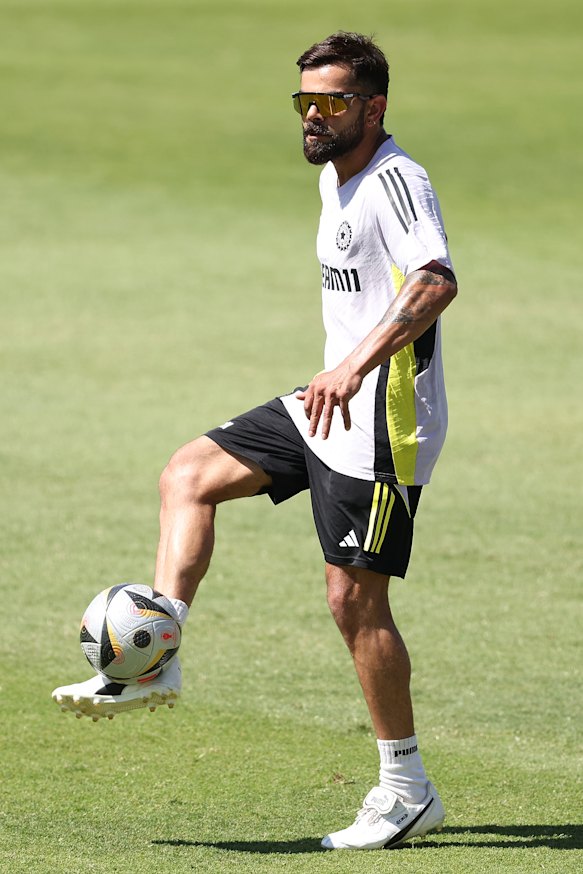 Virat Kohli warms up with a game of soccer on Wednesday.