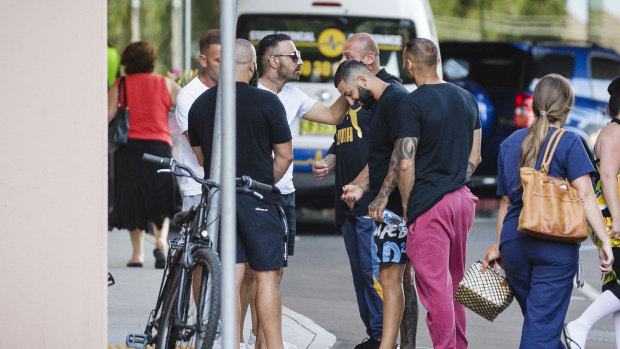 People gather outside St George Hospital, where Hawi died on Thursday. 