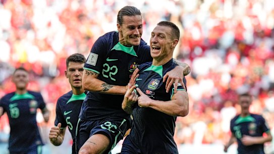 Mitchell Duke celebrates scoring Australia’s goal with Jackson Irvine.