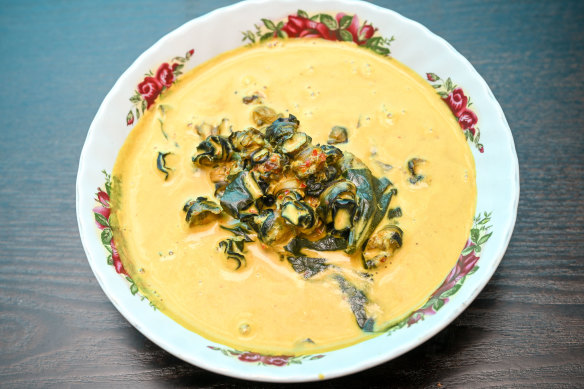Yellow curry with betel leaves and black freshwater snails.