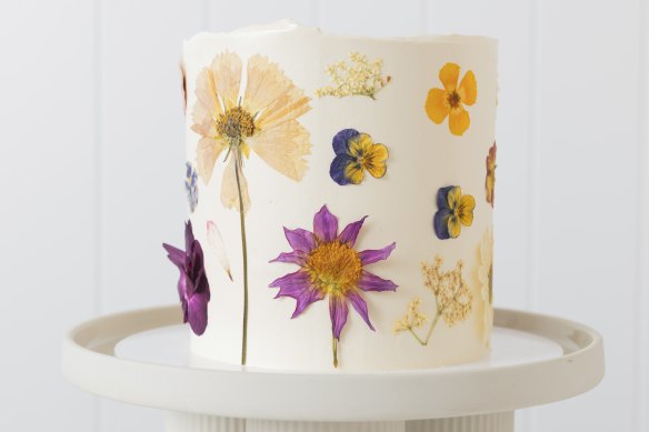 A custom cake decorated with edible flowers.