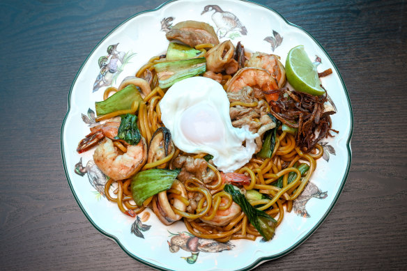 Hokkien noodles stir-fried with prawns, mussels and sliced pork, and topped with dried fish and runny fried egg.