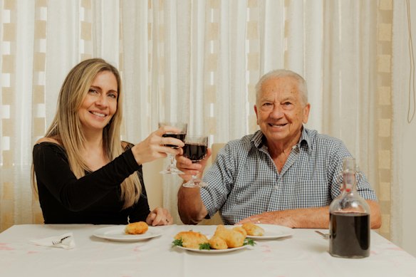 Jessica Timpano and her nonno, Bart Nicoliello, enjoy home-made croquettes and wine.