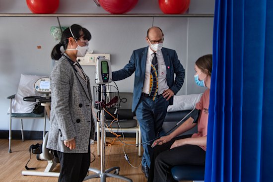 Professor Steven Faux and Dr Morgan Hee (left) meet with long COVID patient Payton Jacobs in March.
