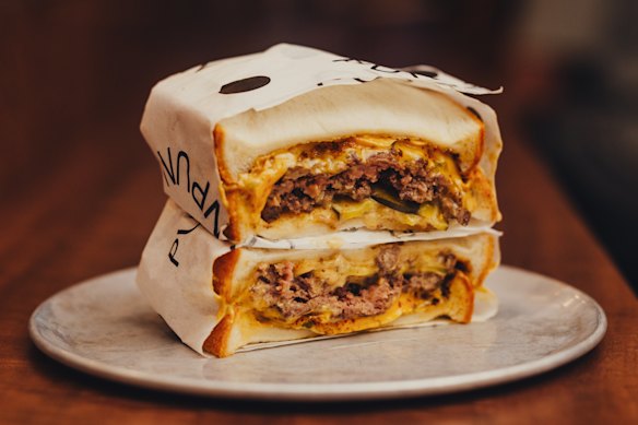 Beef smash patty sandwich with pickles and Tokyo mac sauce.