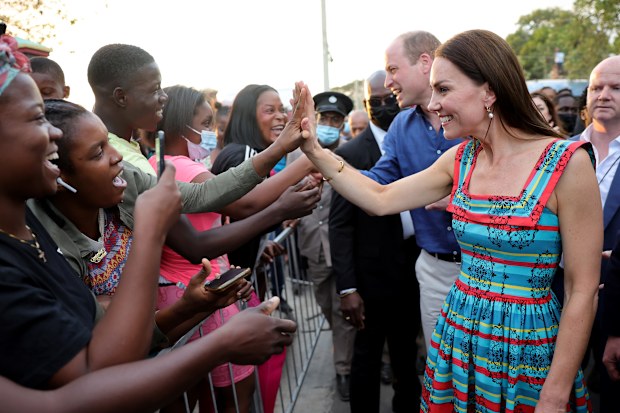 Prince William, Duke of Cambridge and Catherine, Duchess of Cambridge shake hands with people during a visit to Trench Town, the birthplace of reggae music, on day four of the Platinum Jubilee Royal Tour of the Caribbean on March 22, 2022 in Kingston, Jamaica.  
