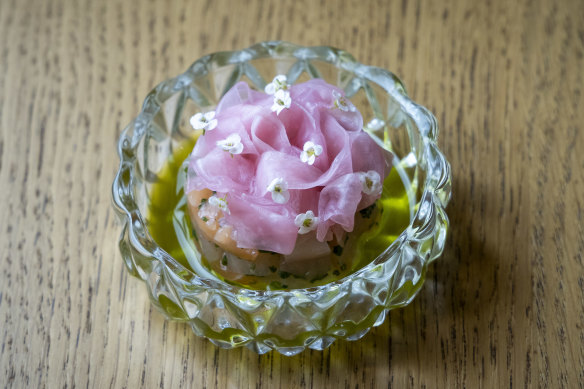 Ruffles of sashimi presented in a ramekin.