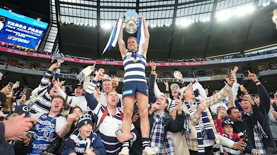 Joel Selwood takes to the stands with the premiership cup.