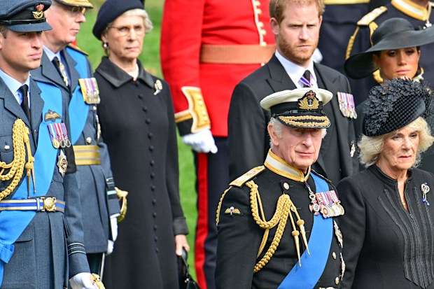 Prince William, Prince of Wales, Prince Harry, Duke of Sussex, Meghan, Duchess of Sussex, King Charles III, Camilla, Queen Consort, Princess Anne, Princess Royal and Princess Beatrice observe the coffin of Queen Elizabeth II as it is transferred from the gun carriage to the hearse at Wellington Arch following the State Funeral of Queen Elizabeth II at Westminster Abbey on September 19, 2022 in London
