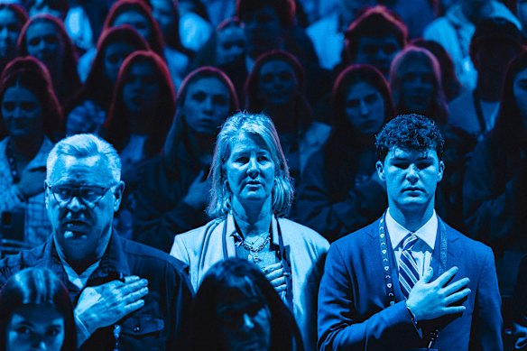 Standing for the national anthem at the AmericaFest convention.