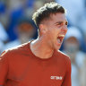 Thanasi Kokkinakis celebrates after defeating Stan Wawrinka in the second round of the French Open.
