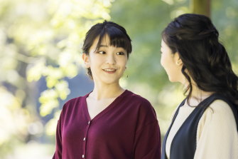Princess Mako, left, talks to her younger sister Princess Kako, in the garden of their Akasaka imperial residence in Tokyo earlier this month.
