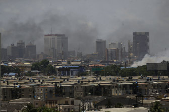 Smokes rise from government buildings set on fire by protesters in Lagos, Nigeria, on Wednesday.