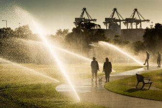 As the sprinklers dance and whistle in the spring sunshine, it's a time like no other for a morning stroll along Williamstown's Esplanade. The cranes of the city's port stand sentinel in the background as locals take to the shiny paths on the edge of summer and of hard-won freedoms in the new COVID normal.  