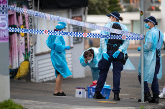 Police and staff in PPE outside Noah’s Backpackers in Bondi on Thursday.