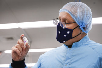 Prime Minister Scott Morrison with a vial of the Oxford-AstraZeneca vaccine. 