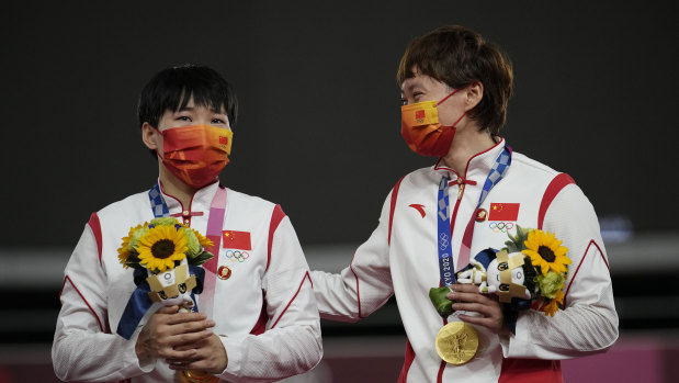 China’s Bao Shanju and Zhong Tiansh wear Mao pins on the dias on Monday.