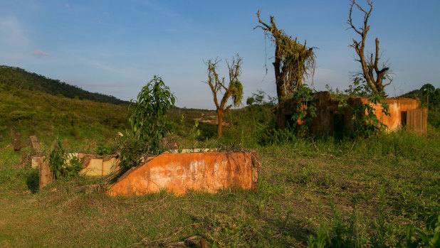 The mud created a new ground level now covered in grass and obscuring what is left of a row of houses in Bento Rodrigues. 