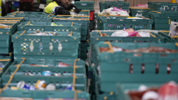 A volunteer from the charity ‘The Felix Project’ collects food at their storage hub in London.