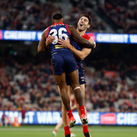 Kysaiah Pickett and Christian Petracca of the Dees celebrate a goal.