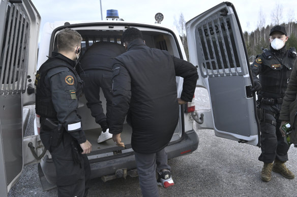 Migrants arriving from Russia board a van to be transported to the Joutseno Reception Centre at the Nuijamaa border station between Russia and Finland in Lappeenranta, Finland.