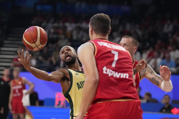 Patty Mills battles German centre Johannes Voigtmann.