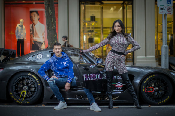 Harrolds luxury department store managing director Ross Poulakis (wearing Amiri) and womenswear manager Jessica Poon (wearing Balmain and Amina Muaddi boots) pose with their liveried Mercedes at their flagship store in Collins St, Melbourne.