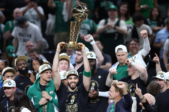 The Boston Celtics’ Jayson Tatum lifts the Larry O’Brien Championship Trophy.