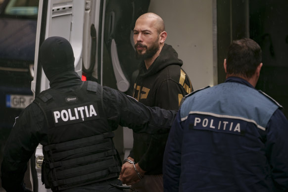 Andrew Tate being led by police in to Romania’s Court of Appeal in Bucharest in March 2024.