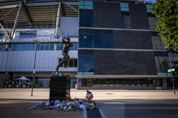 Tributes left earlier this month at a makeshift memorial at the Shane Warne statue at the MCG.