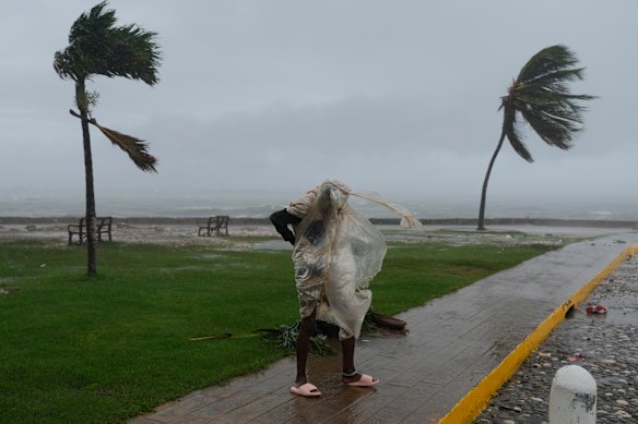 A man fights the weather in Kingston, Jamaica, as Hurricane Melissa approaches.