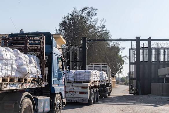 Trucks carrying aid enter Gaza through the Rafah border crossing with Egypt on Sunday.