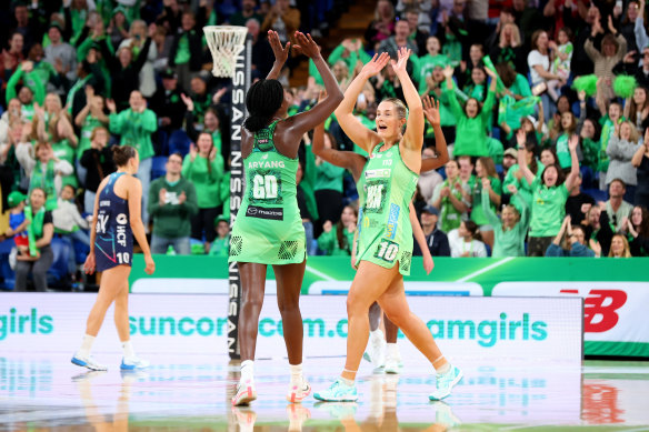 Alice Teague-Neeld and Sunday Aryang celebrate as West Coast Fever booked their spot in a preliminary final against NSW Swifts.