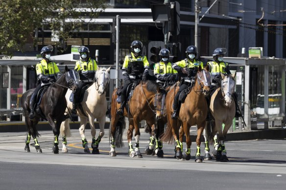 Police from the mounted branch outside the Queen Victoria market this morning.