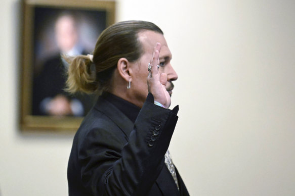 Actor Johnny Depp is sworn in at the trial.