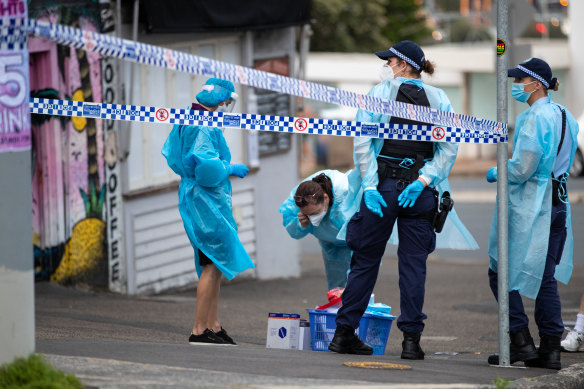 Police and staff in PPE outside Noah’s Backpackers in Bondi on Thursday.